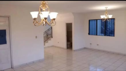 Large living room with chandelier and staircase in rental house David Chiriquí