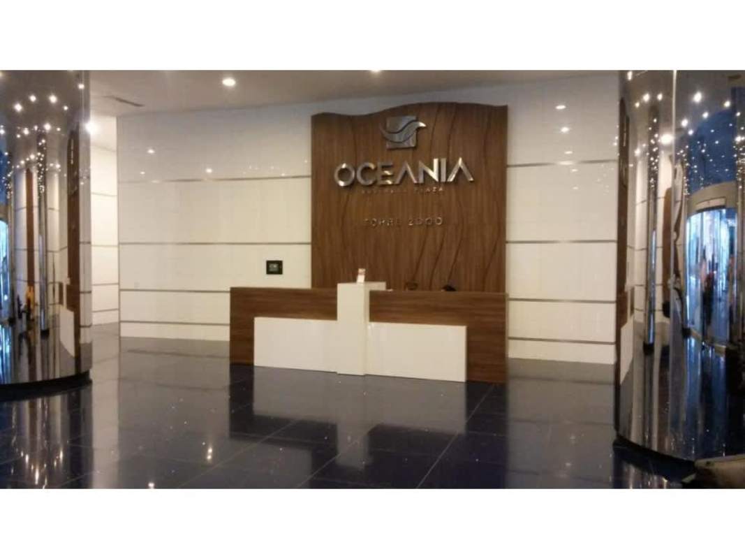 Contemporary reception lobby with Oceania signage, wood accent wall, mirrored columns in Punta Pacifica office tower
