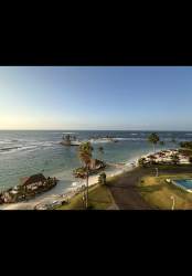 Modern bathroom with double sinks, large mirror, glass shower Playa Escondida condo Caribbean Panama