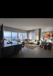 Large oceanfront terrace with BBQ and lounge seating in Playa Escondida, Panama luxury apartment