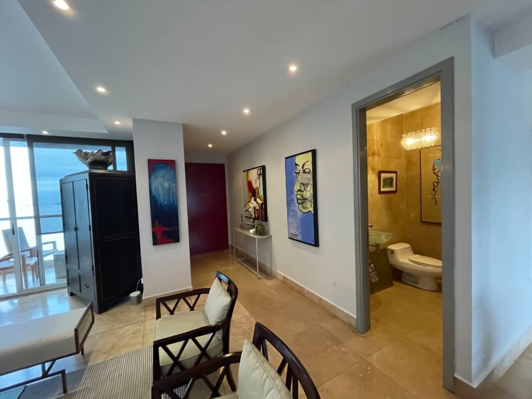 Master bedroom with wooden floor, large windows and ocean view in Aquamare Punta Pacifica Panama