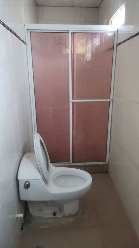 Simple bathroom with shower enclosure in affordable house Pacora Panama