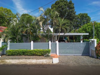 Gated facade with fence of single-family house for sale Las Tablas