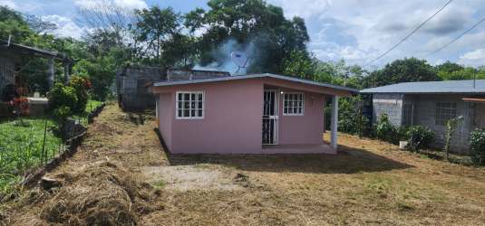 Front porch of small house with large yard fenced in El Coco La Chorrera Panama