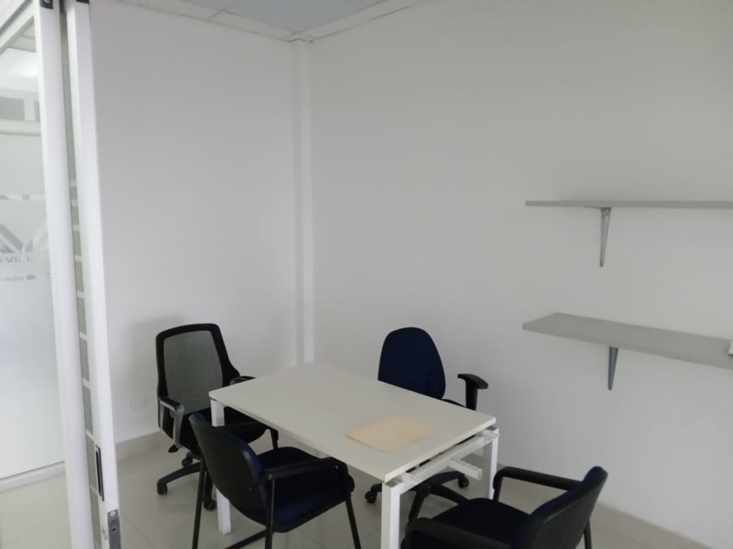 Ample training or conference room in commercial office with blue chairs and glass partitions El Carmen Panama City