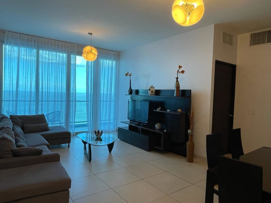 Open-concept dining area with large windows and ocean views at PH Destiny