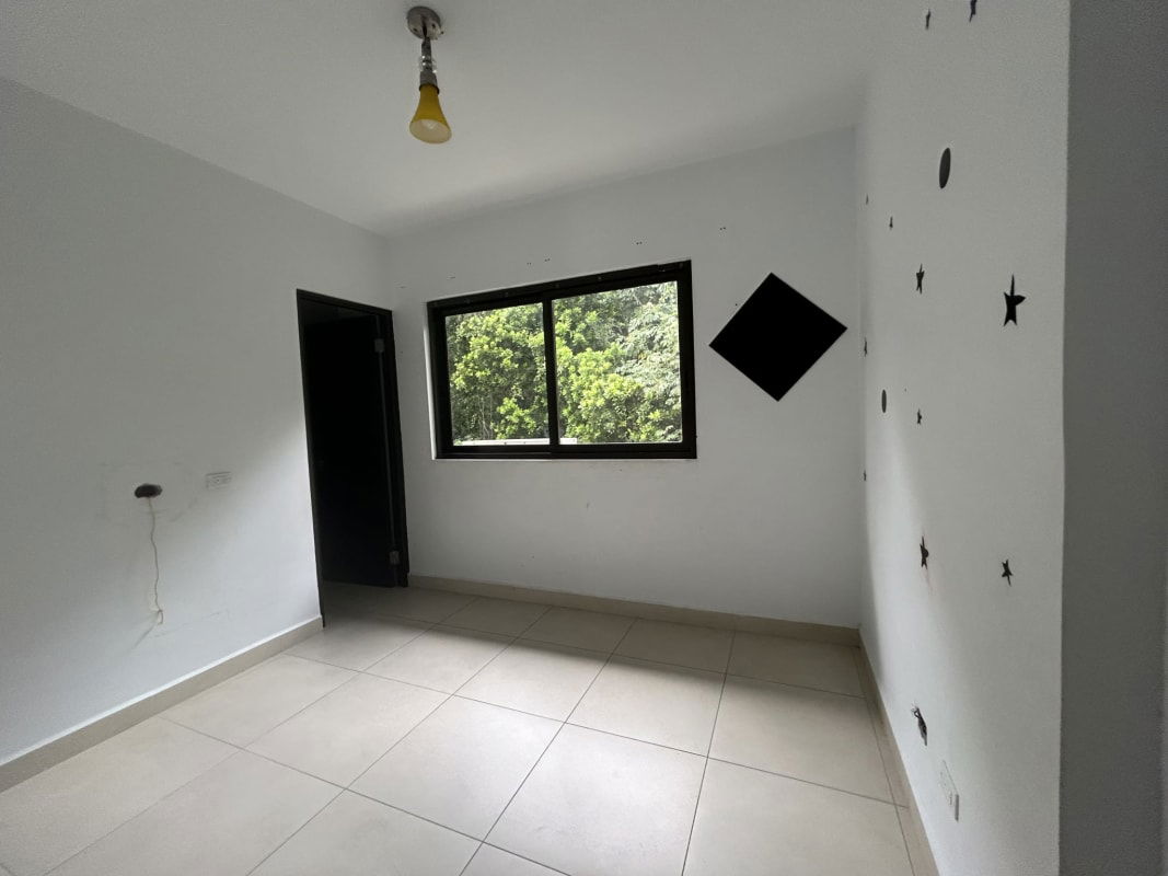 Spacious built-in walk-in closet with shelves, drawers, and dark wood finish at PH Embassy Village Clayton Panama