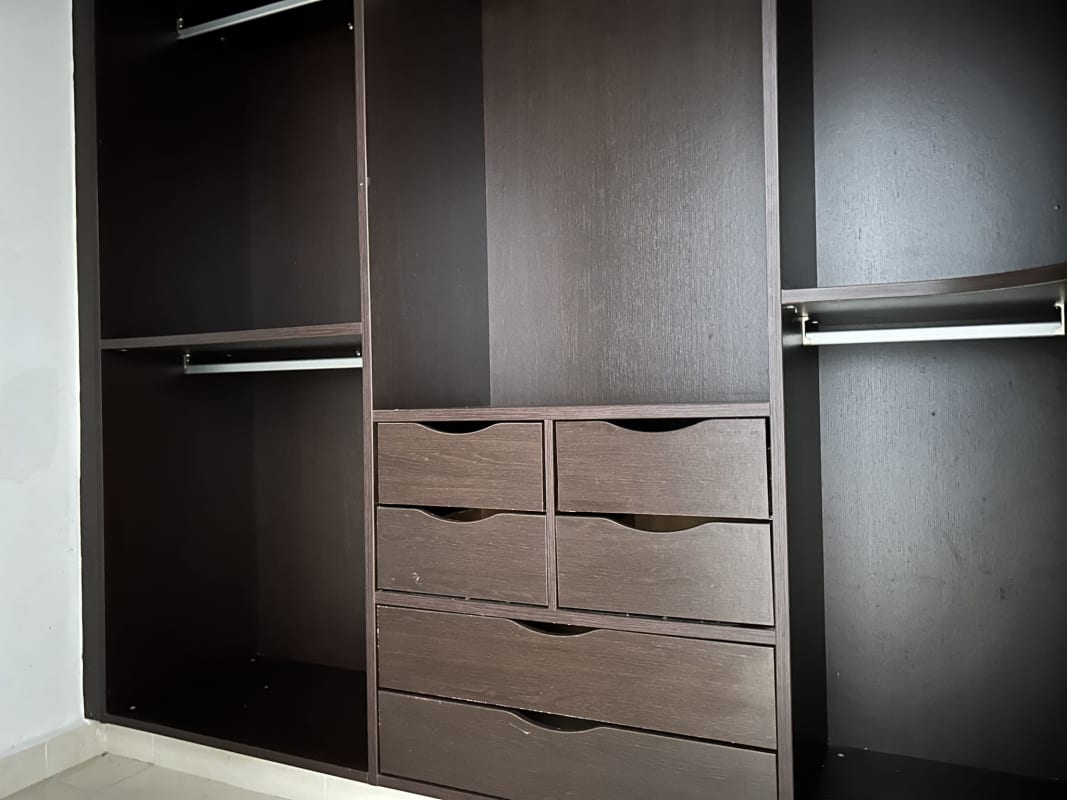 Bathroom with double sink vanity, large mirror, glass shower enclosure, beige tiles in Embassy Village Clayton Panama