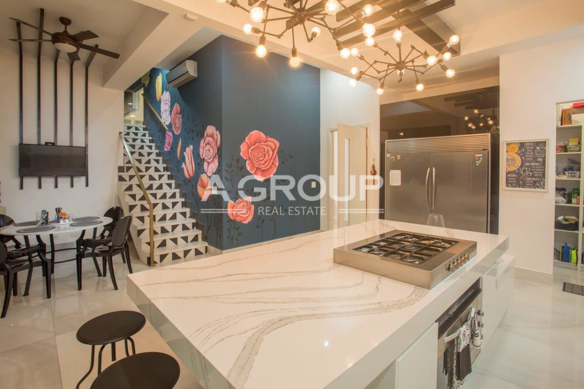 Luxurious marble bathroom with freestanding tub large mirror vanity chandelier in Costa del Este