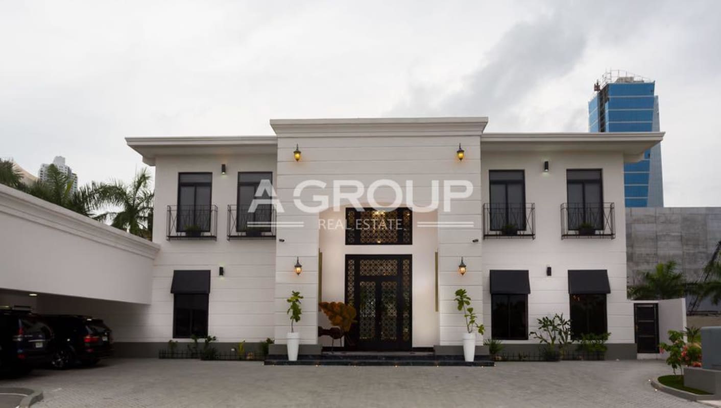 Two-story Mediterranean-inspired luxury residence elegant exterior balconies driveway Panama