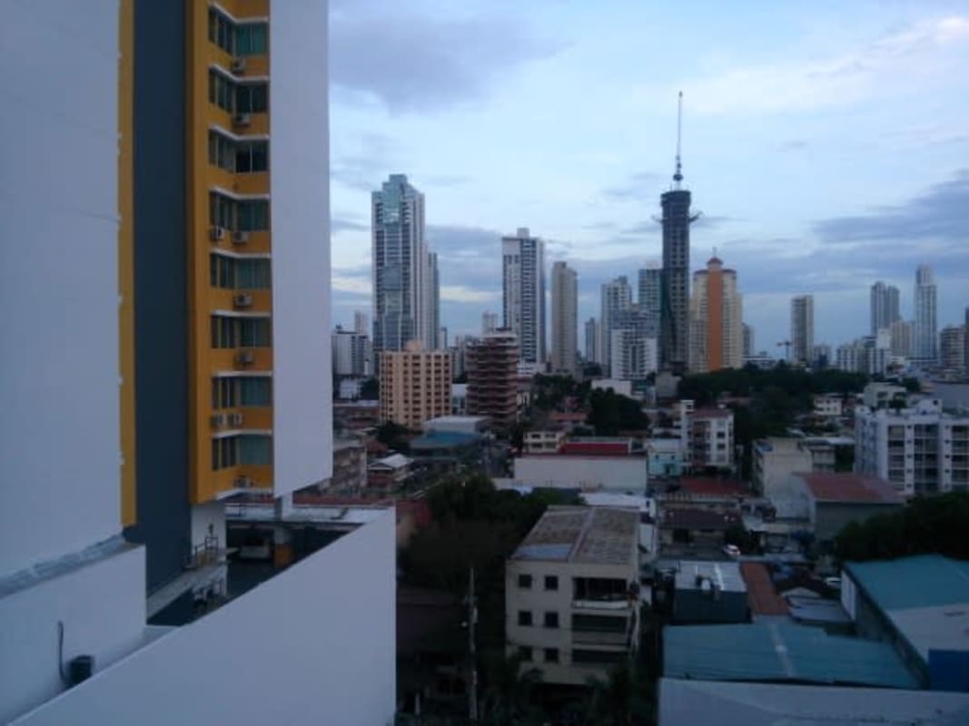 Furnished bedroom with large window, closet space, and city view in PH Cosmopolitan Panama