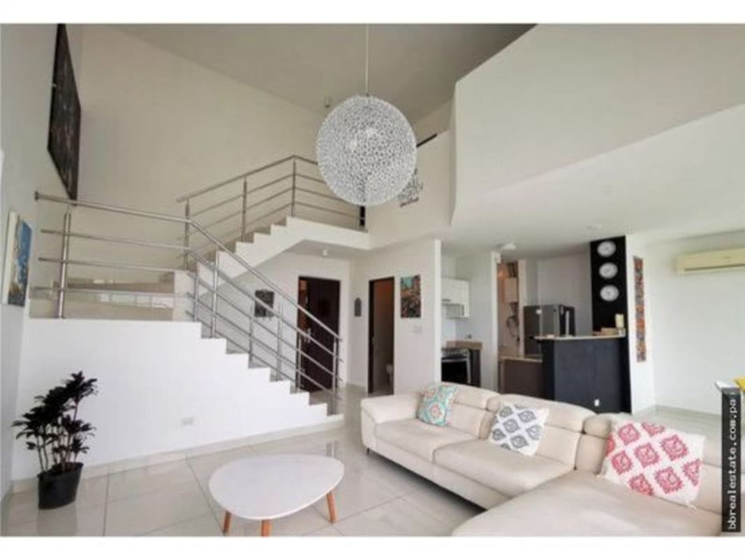 Living room with panoramic city view through large windows PH Park Loft Panama