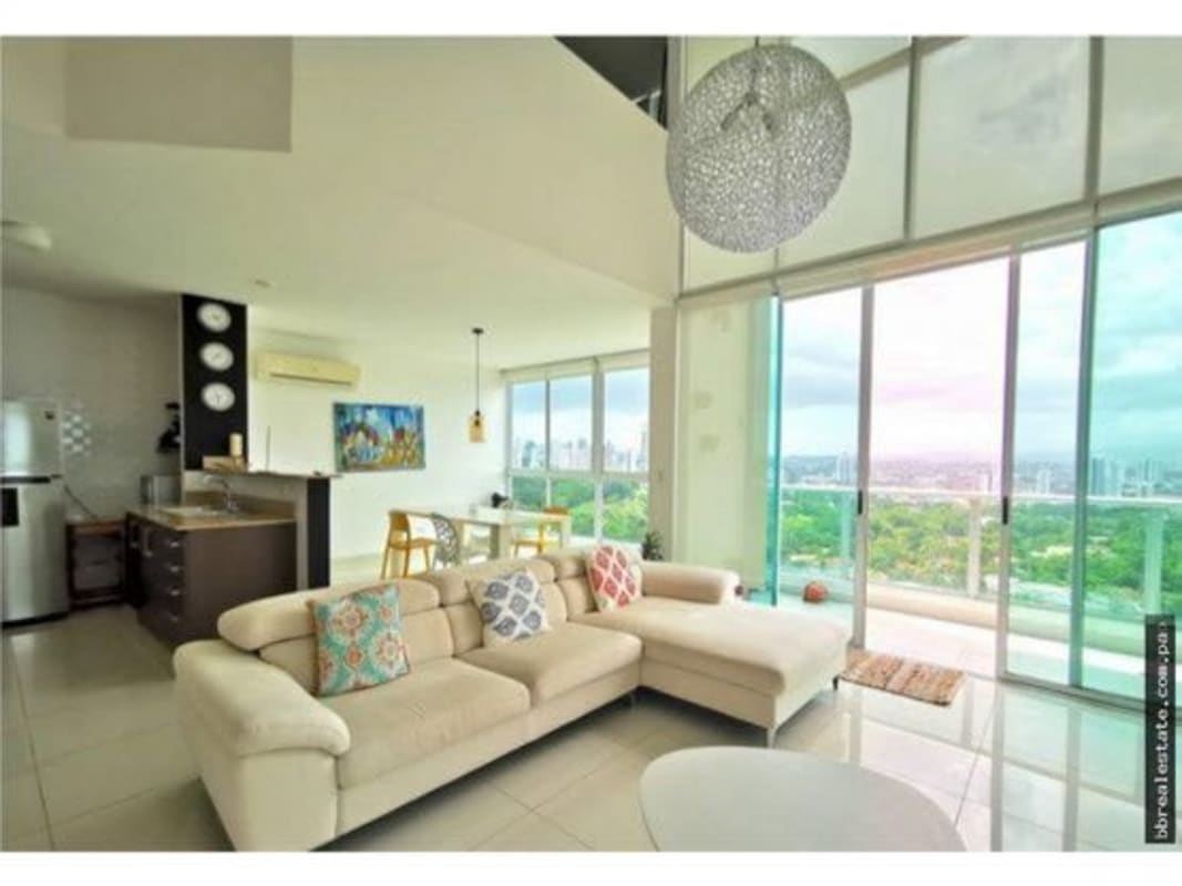 Open plan living dining area with modern staircase high ceiling PH Park Loft Panama