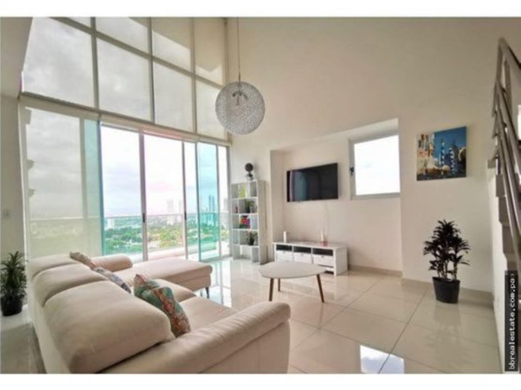 Dining area with city view large windows modern furniture PH Park Loft Panama