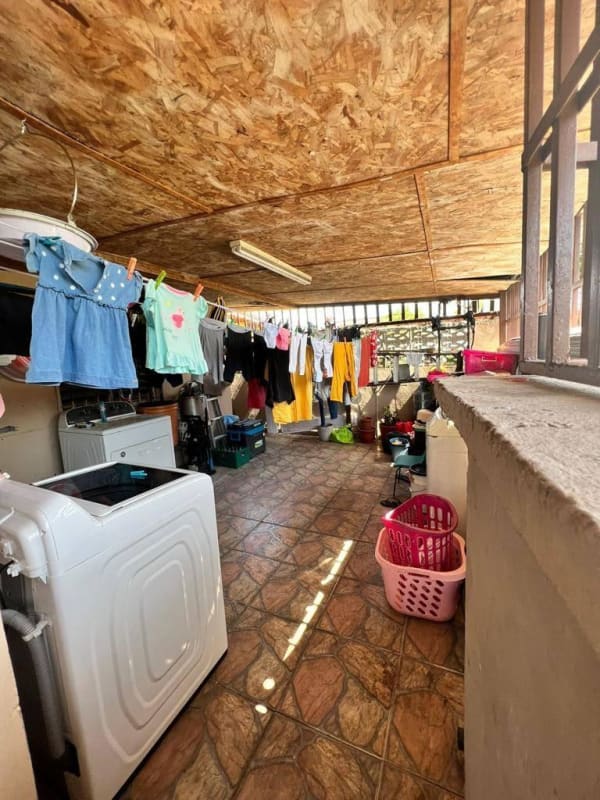 Functional laundry room with washer hanging clothes Don Bosco neighborhood house Panama