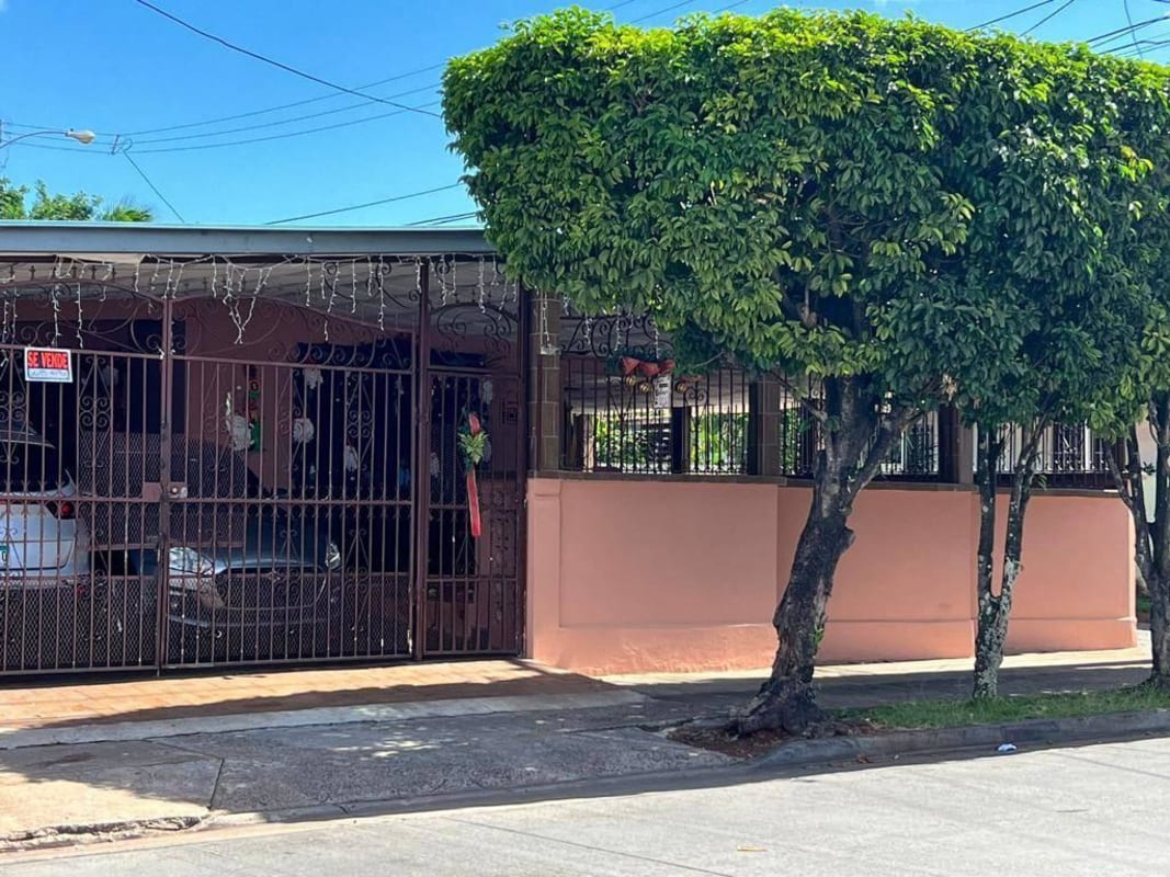 View of front gate, covered parking, garden Don Bosco Panama City house sale