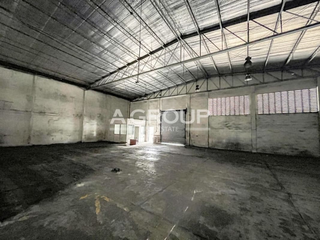 Empty warehouse with roller shutter door high ceiling industrial lighting Panama