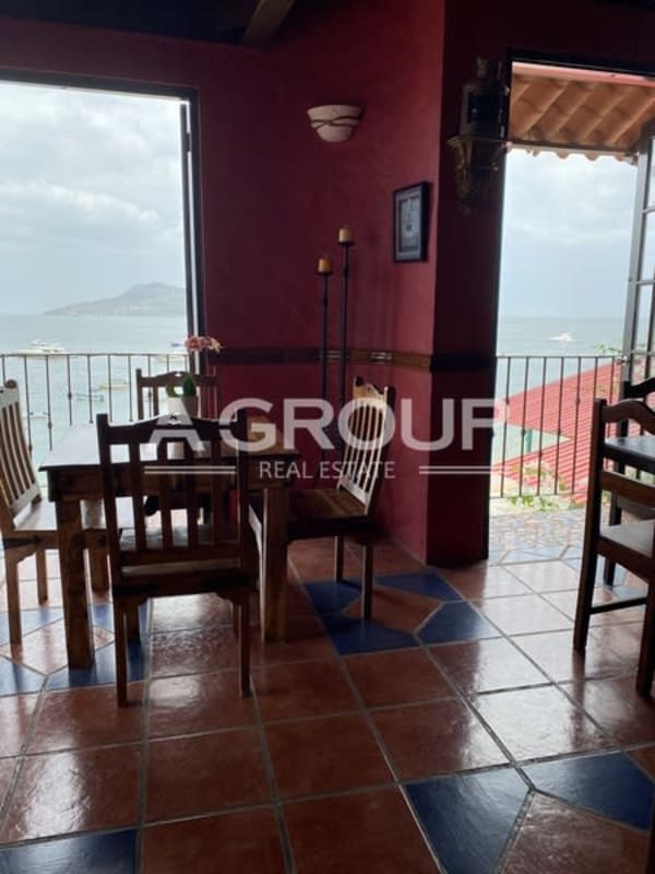 Rustic wooden dining area with colorful tiles in hotel Isla Taboga Panama