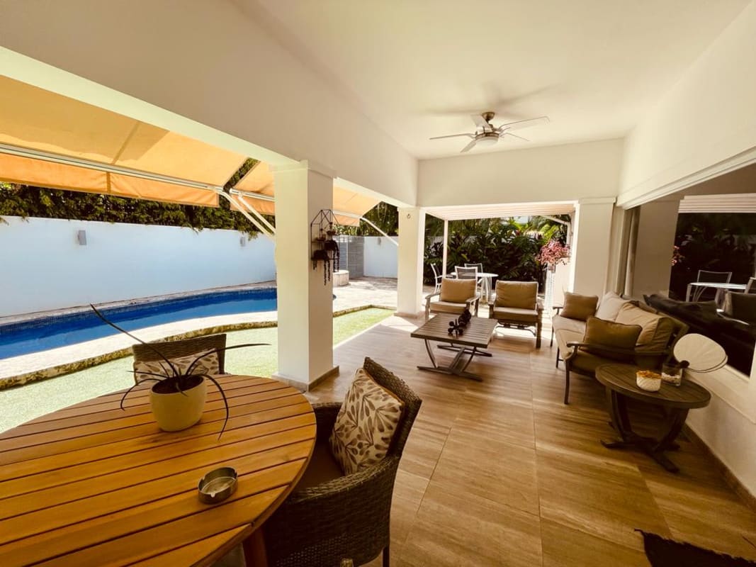 Covered patio with outdoor dining set lounge area pool garden Costa del Este Panama