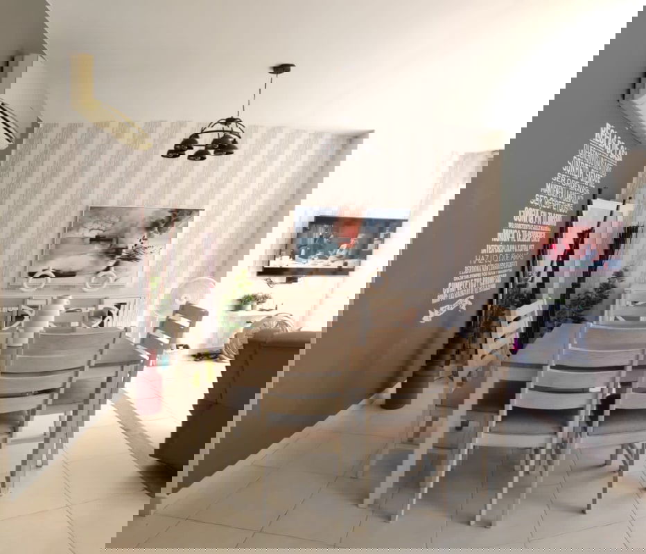 Outdoor patio with bar table, string lights, and wall decor in Versalles Panama home for sale