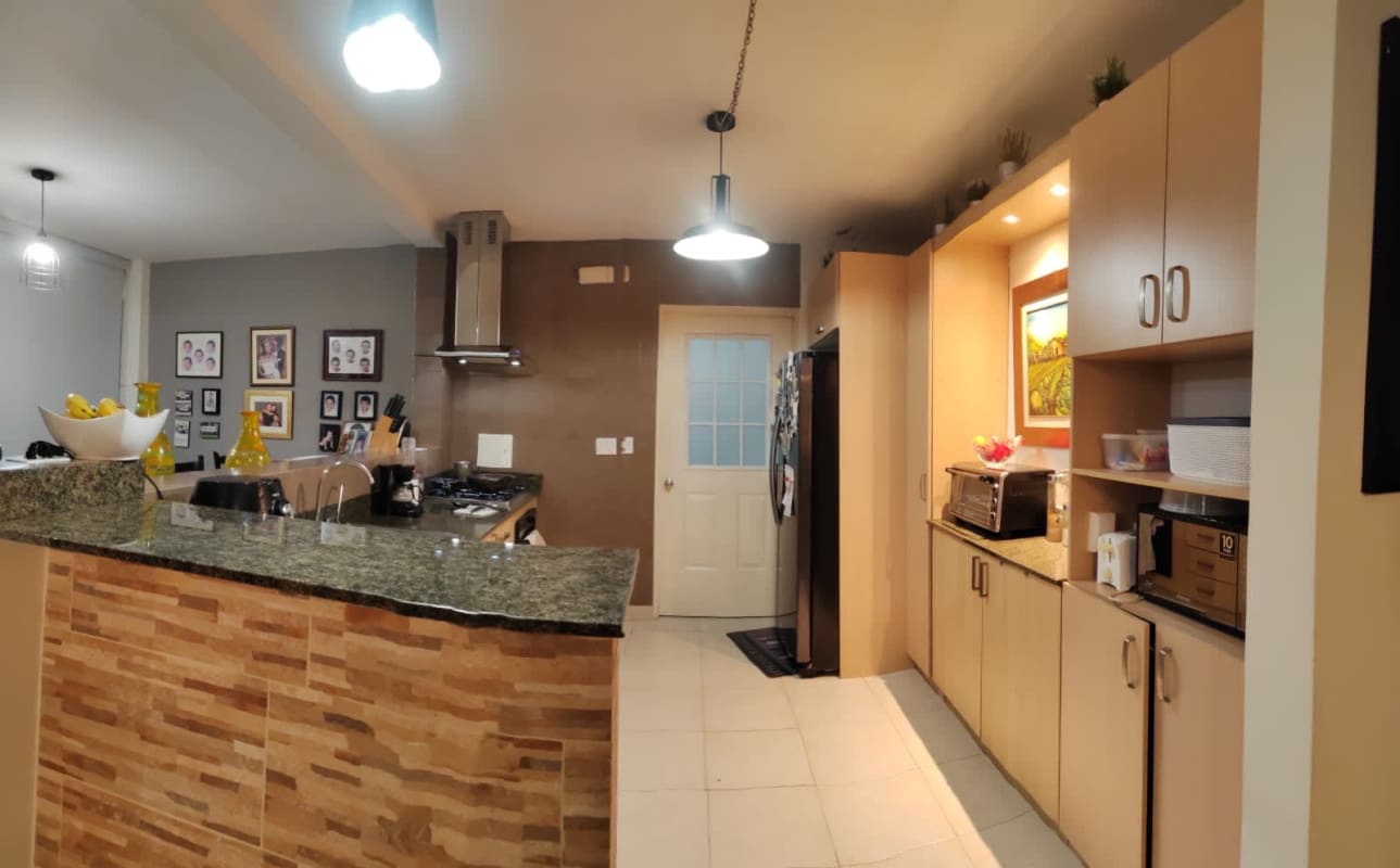 Modern kitchen with granite countertops, breakfast bar and appliances in Versalles Panama City