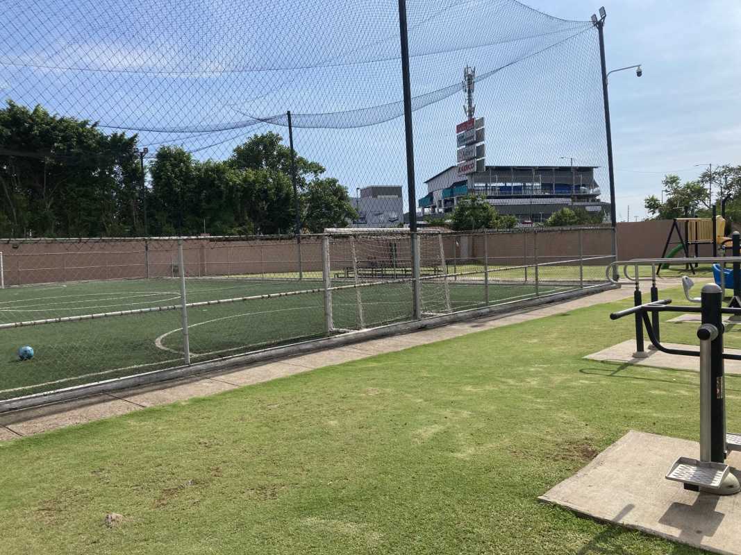 Fenced soccer field and children playground in Versalles community Panama City