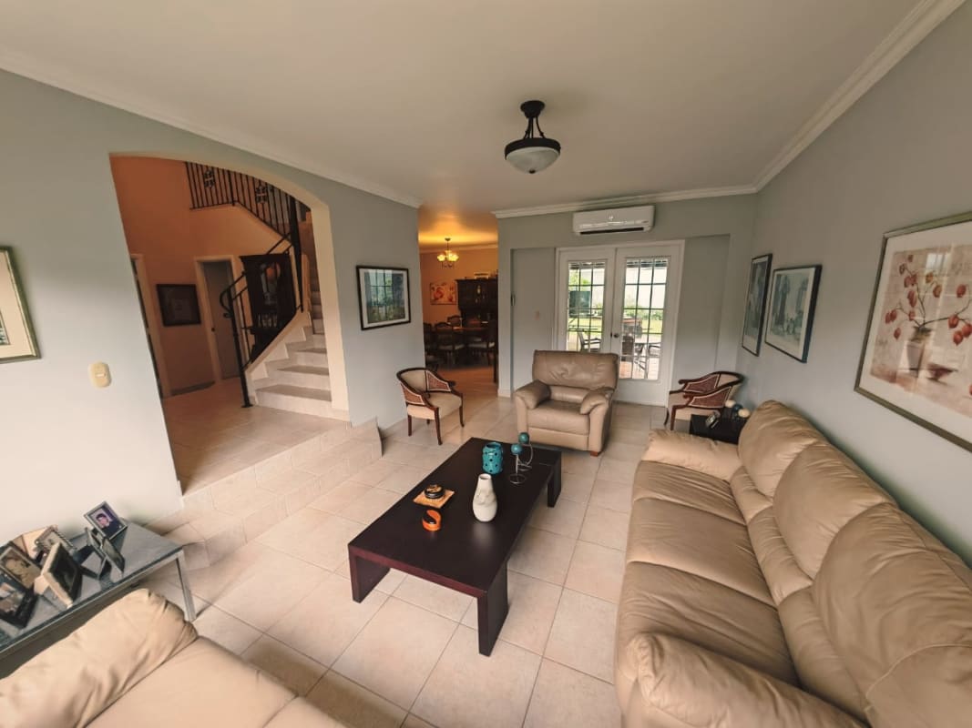 Traditional dining room with large window, chandelier, porcelain tile in Costa Azul Costa del Este