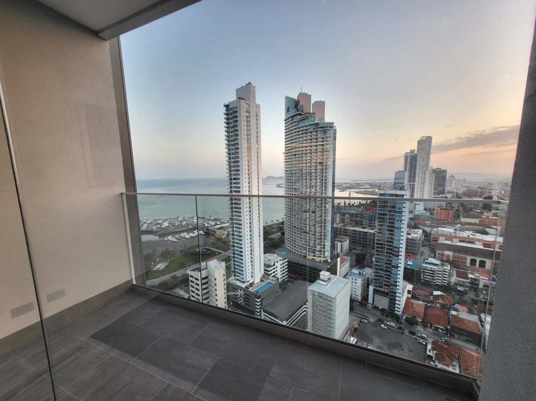 Bright living room with panoramic city and sea views, marble floors, modern furniture at PH Nuovo Panama