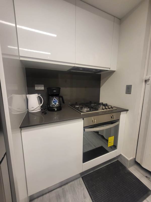 Elegant bathroom with marble walls, glass shower and designer fixtures at PH Nuovo Panama