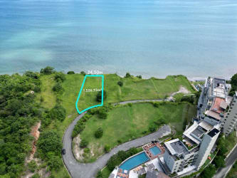 Modern oceanfront condos on grassy cliff by Punta Caelo Panama with turquoise sea view