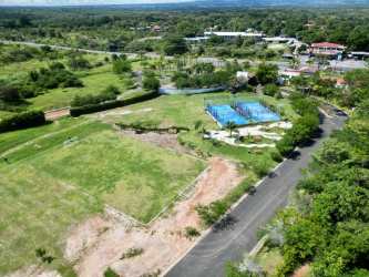 Tennis courts and open green lawns at Punta Caelo beachfront residential community