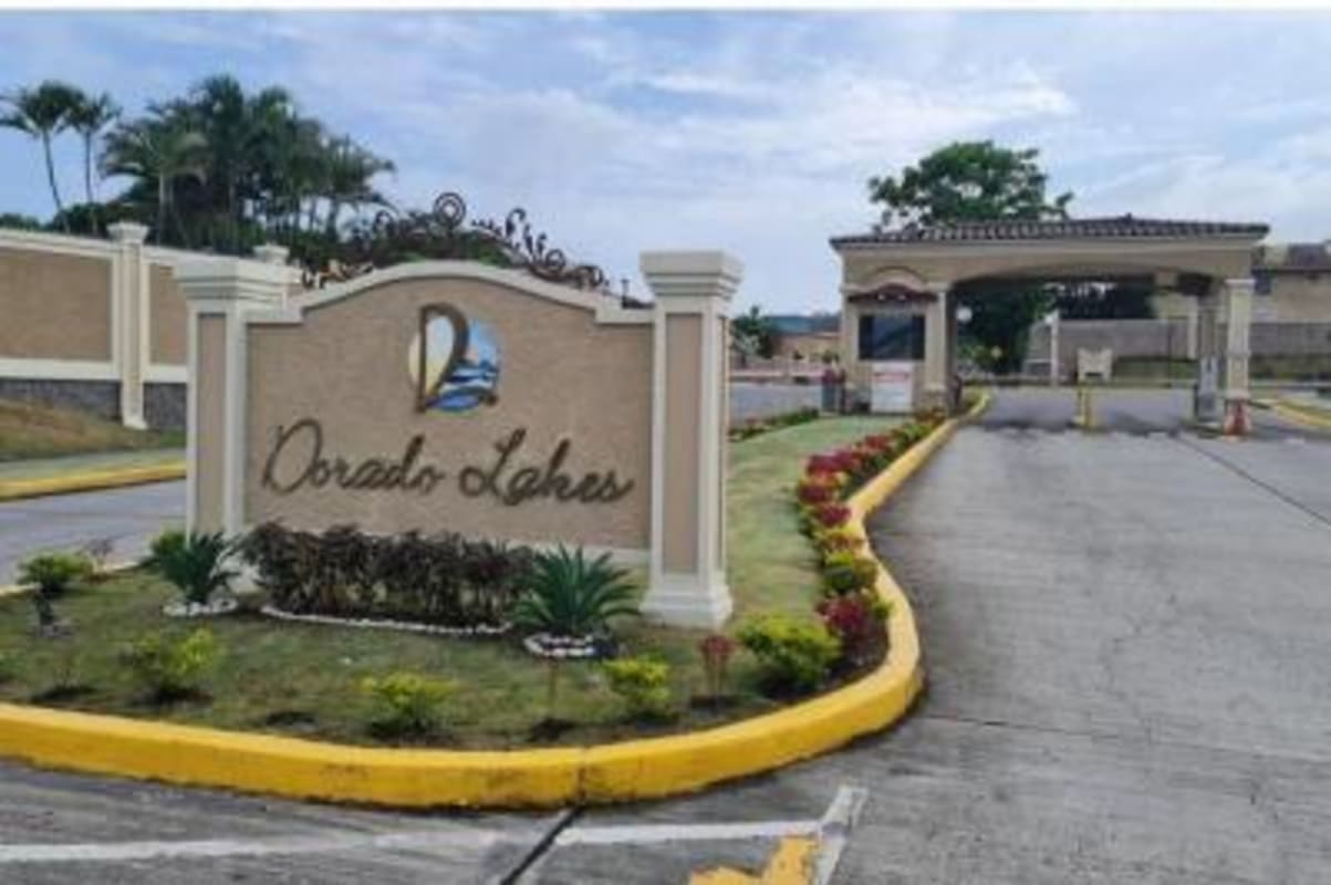 Two-story home with tile roof, porch, carport in Dorado Lakes community