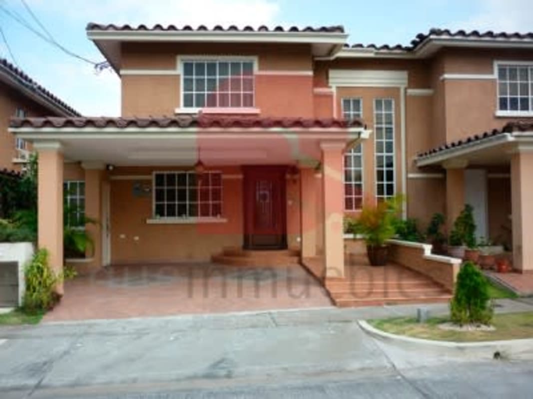 Secure gated entrance with landscaped gardens and signage at Dorado Lakes Panama