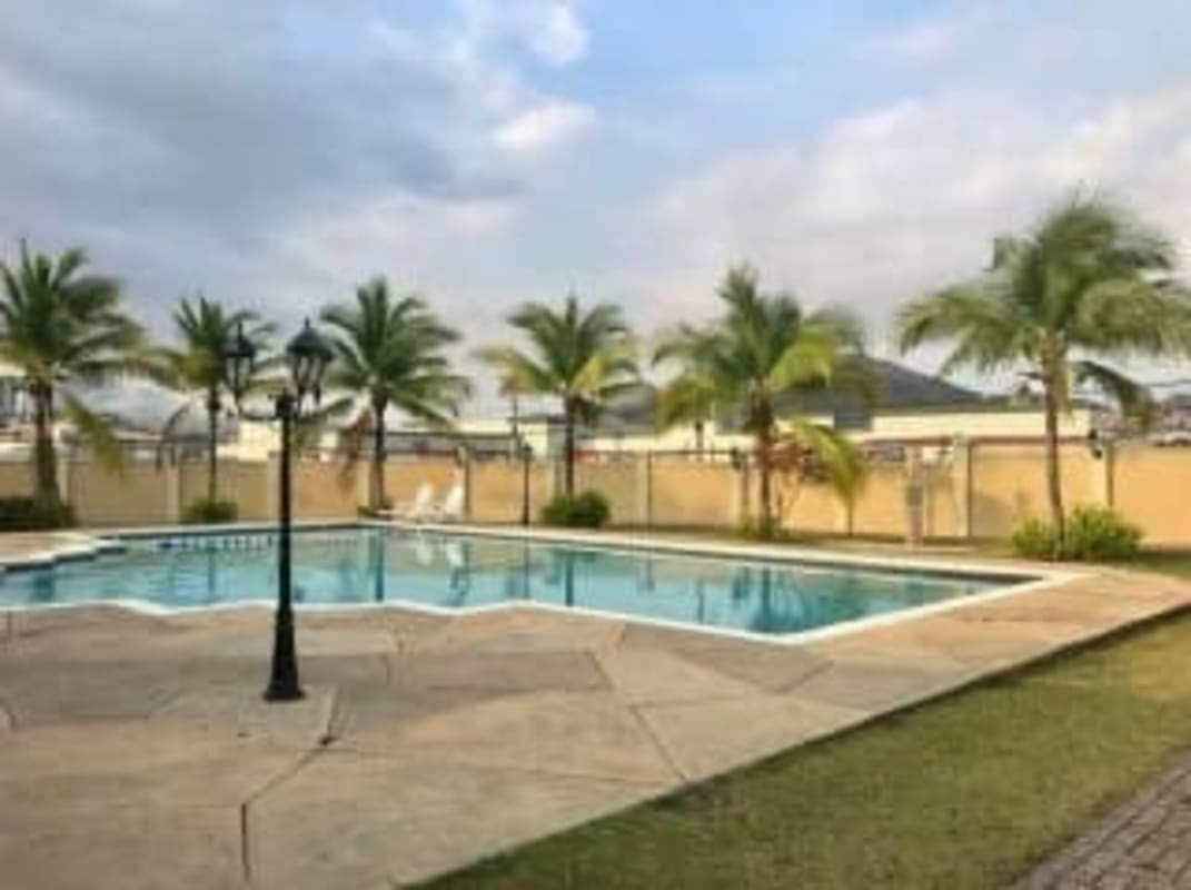 Family-friendly outdoor pool with slides, jacuzzi and lush palm landscaping in Dorado Lakes