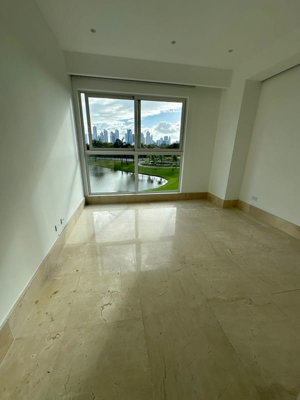 Master bedroom with floor-to-ceiling windows marble floors golf views PH The Reserve Panama City Santa María