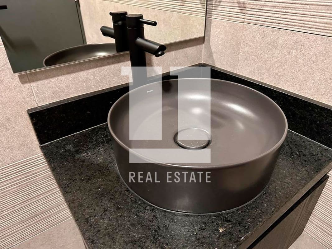 Sleek bathroom with vessel sink, black faucet and textured wall tiles in PH Victory Sport Coco del Mar Panama