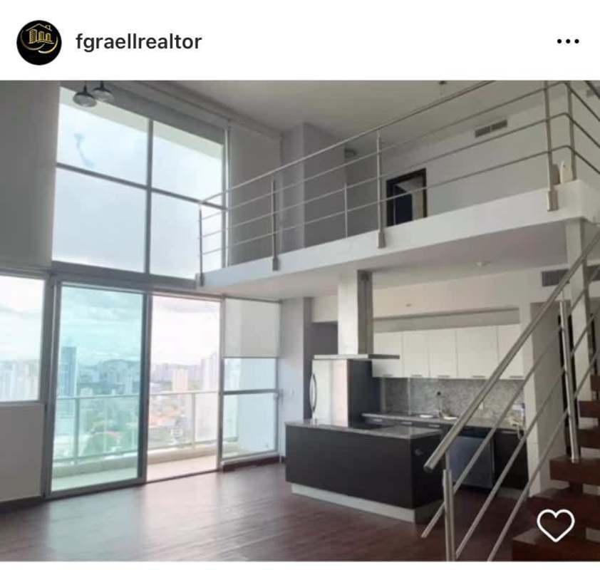 Two-level loft apartment interior with open mezzanine and large windows in PH Ocean Aire Punta Pacifica Panama City