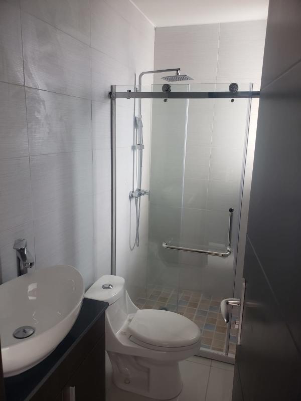 Modern bathroom with vessel sink, granite countertop, glass shower in PH El Carmen Moderno Panama City