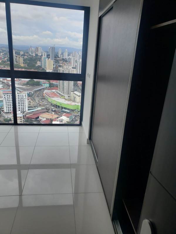 Bedroom in new apartment with full-height windows overlooking skyline PH El Carmen Moderno Panama
