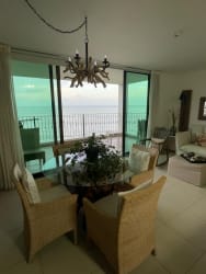 Master bedroom with large window and balcony access overlooking ocean at Lago Mar Ensenada Panama