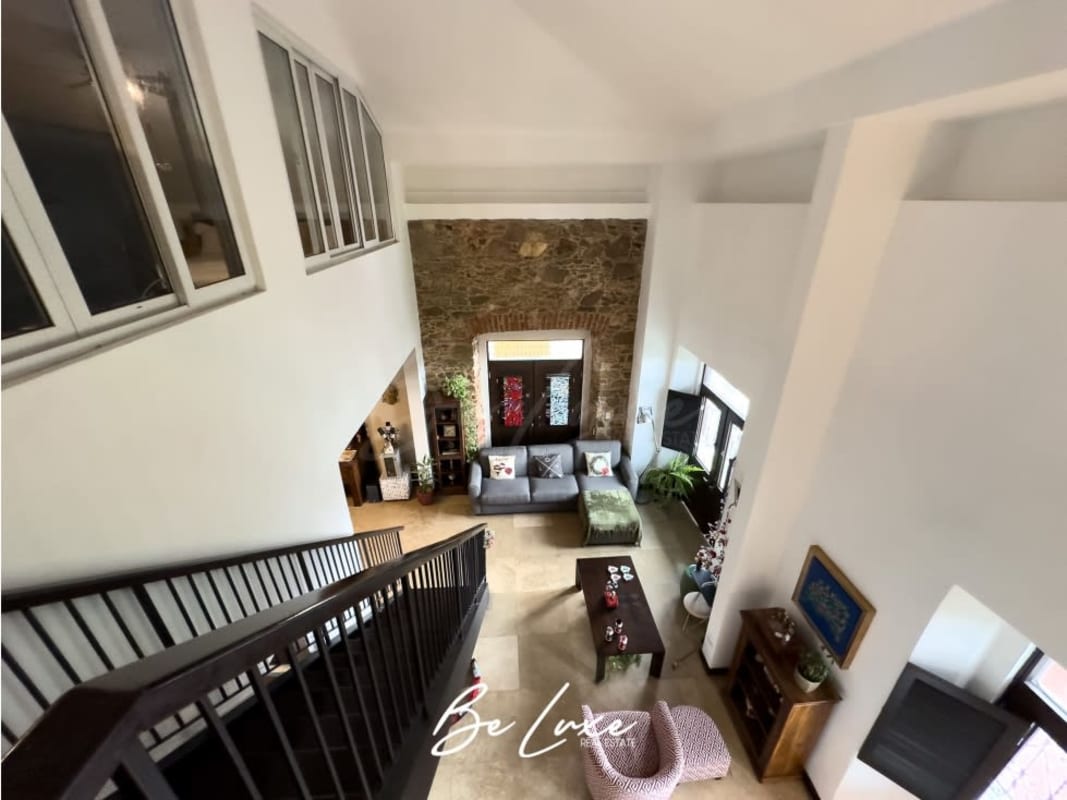 Spacious loft with stone accent, tall ceiling, modern seating in Casco Viejo PH Casa Monte Fiore