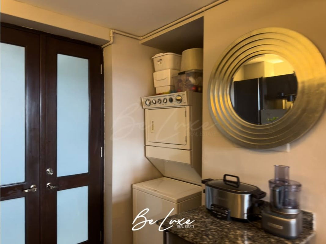 Laundry nook in loft with granite kitchen countertops in Casco Viejo apartment Panama City