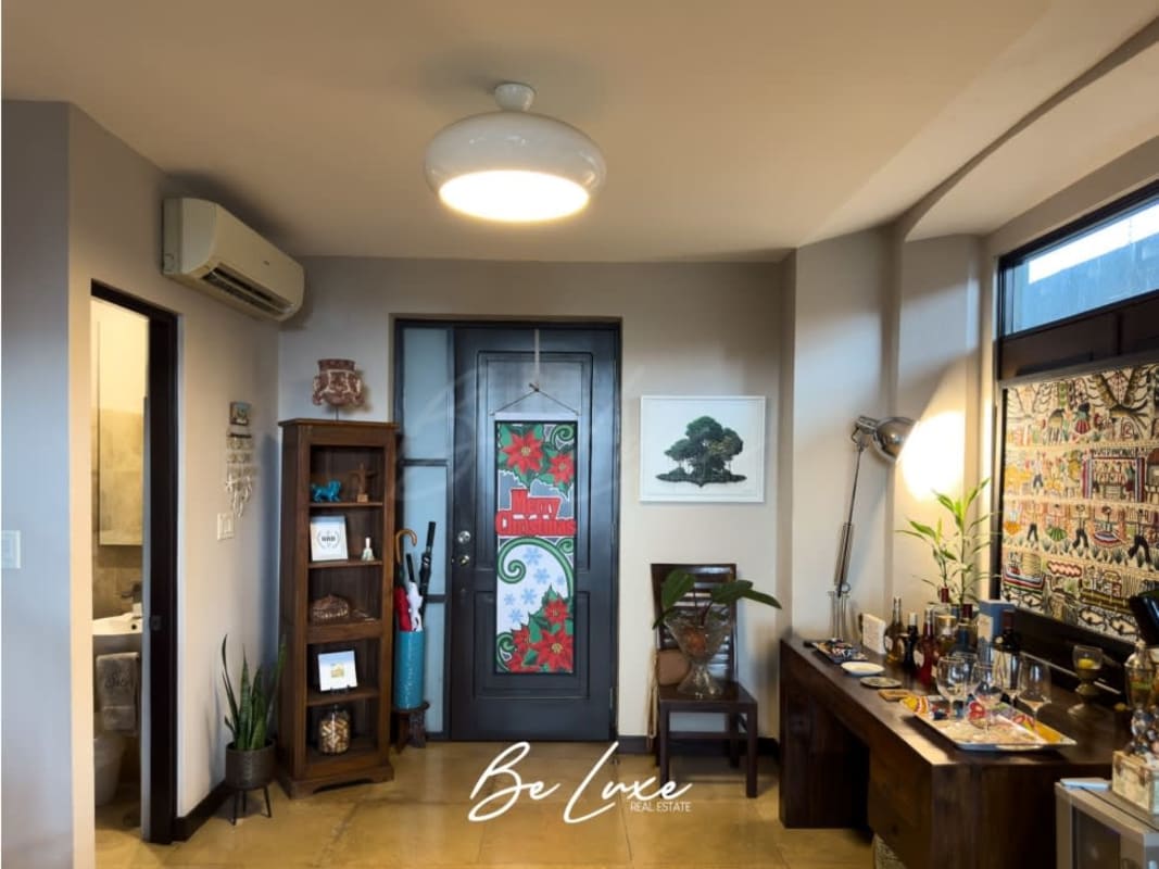 Entrance hall with bar area, wooden furniture, festive decor historic condo Panama