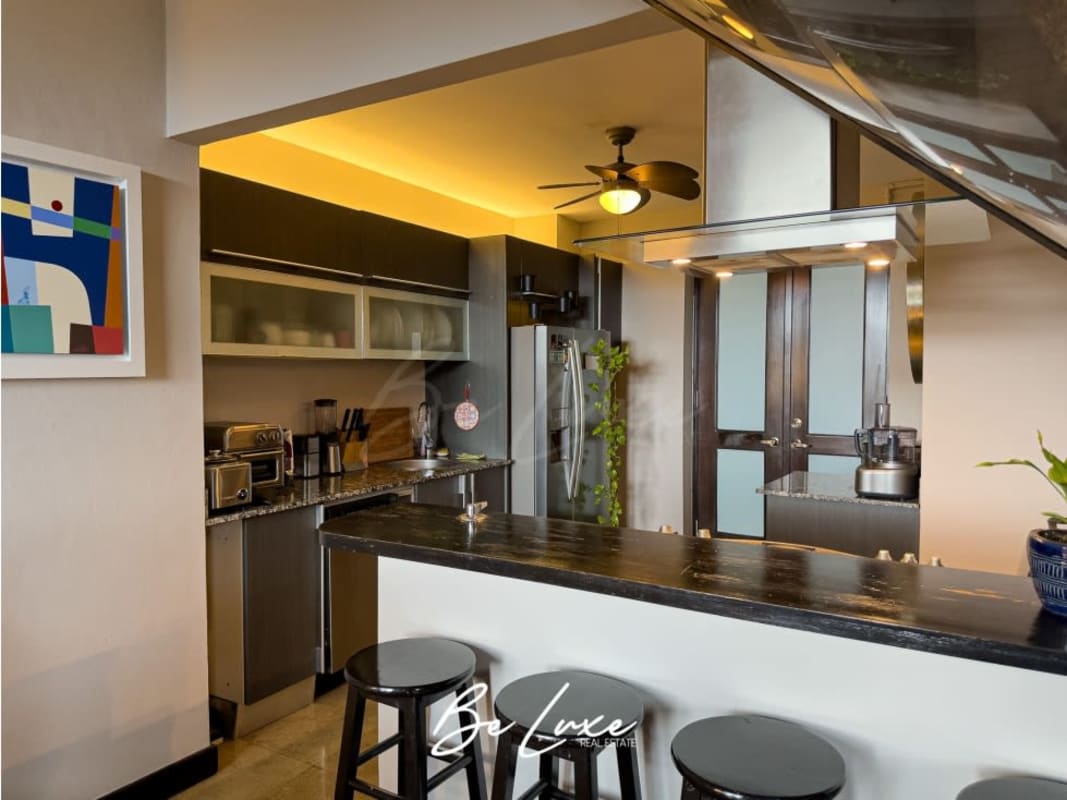 Modern kitchen with stainless appliances granite counters in Casco Viejo historic loft Panama
