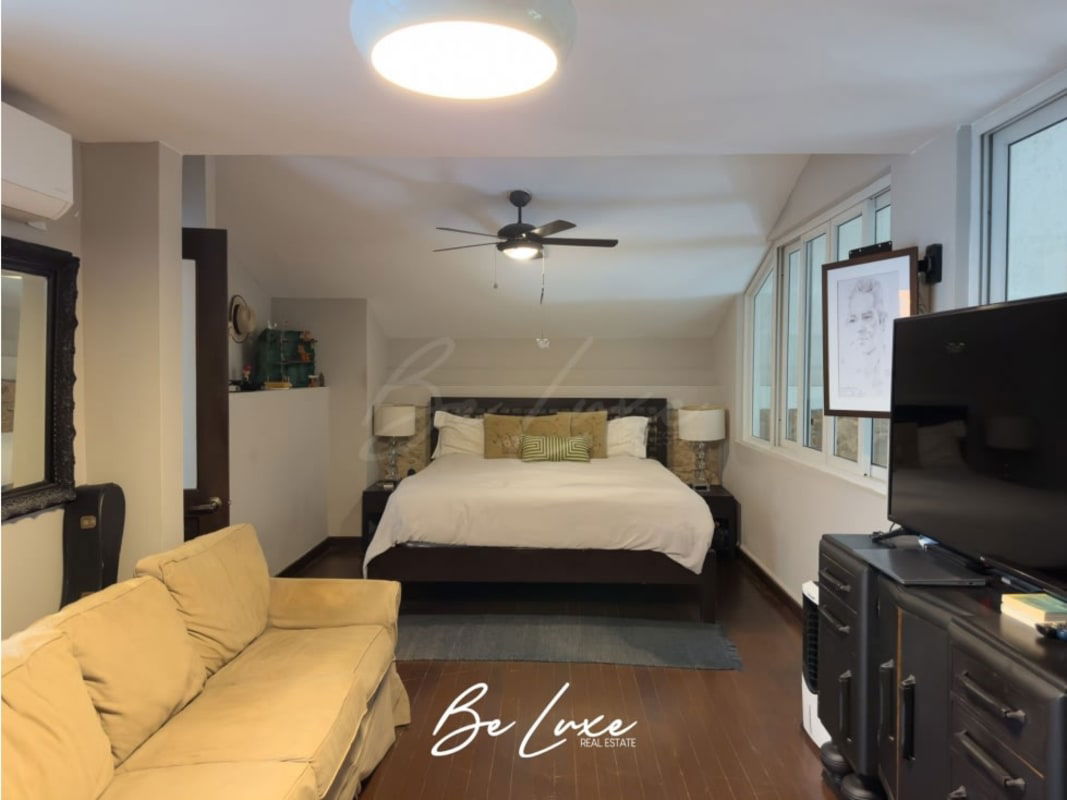 Modern bedroom with large windows, AC, sofa, colonial details Panama Casco Viejo
