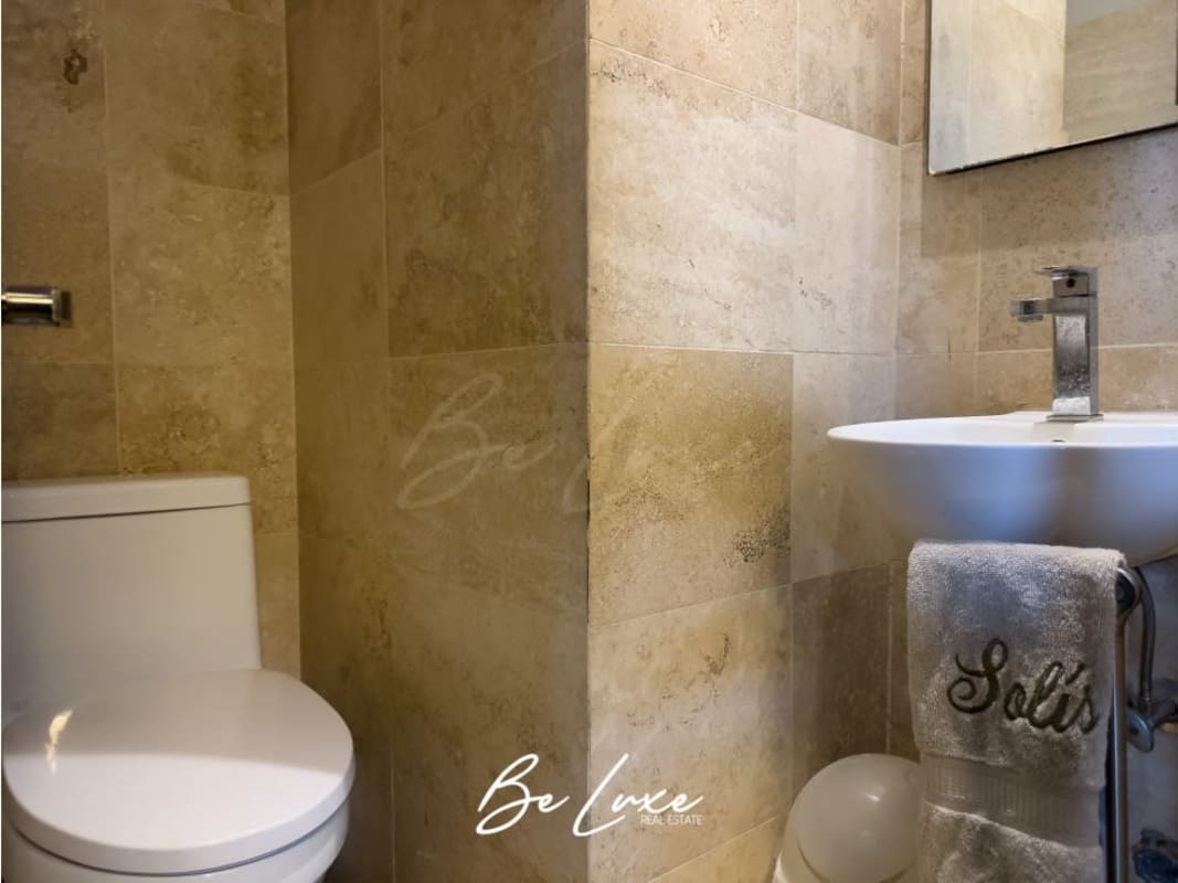 Dining space with rustic stone wall, arched window PH Casa Monte Fiore historic condo Panama