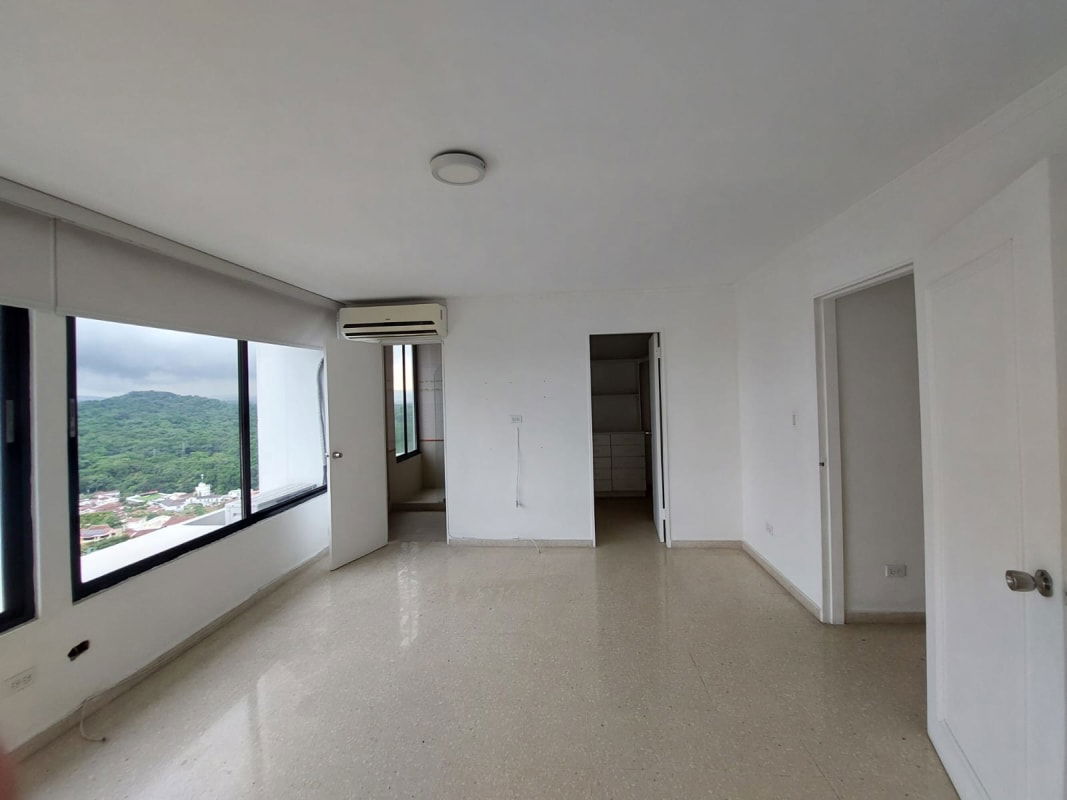 Bedroom with closet, large windows and skyline view at Pacific Hills Tower La Alameda Panama City