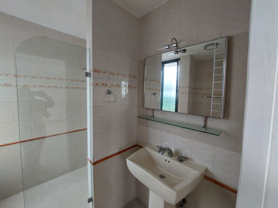 Bathroom with glass shower, large mirror and design tiles PH Pacific Hills Panama