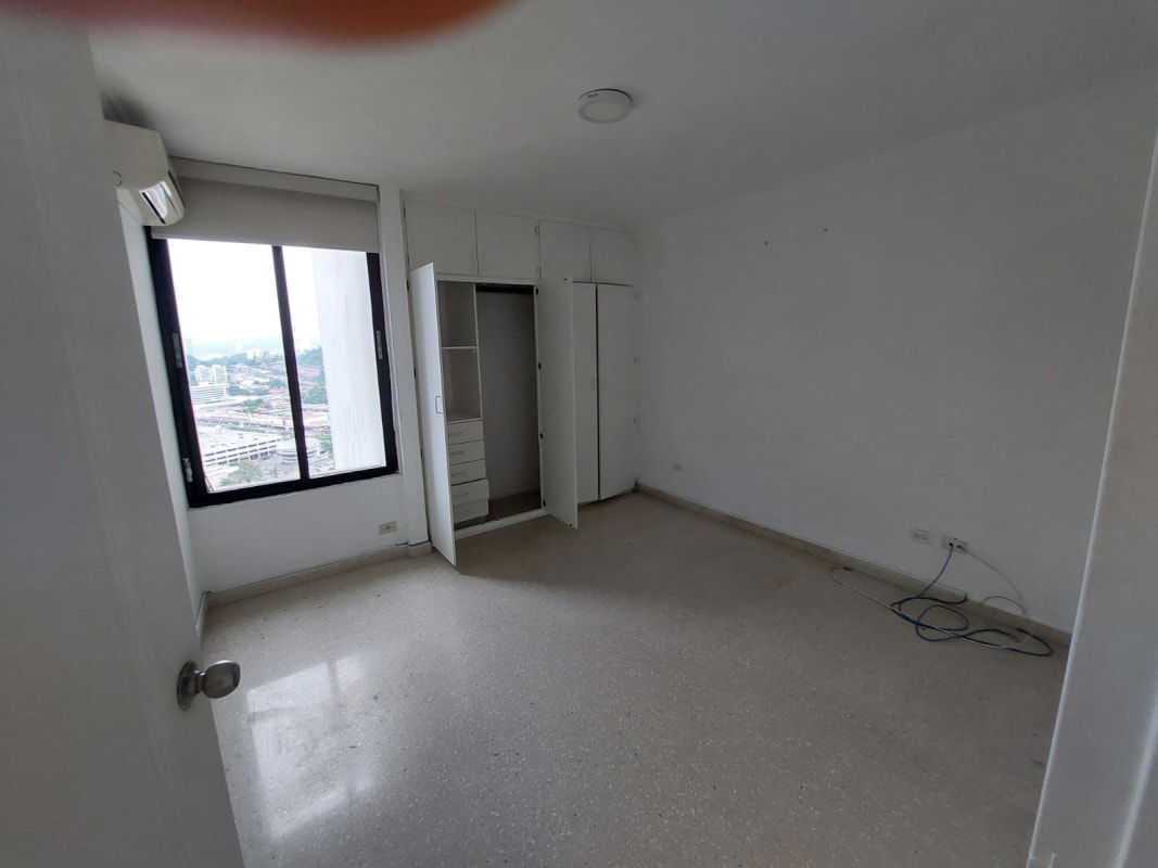 Galley kitchen with granite countertops and white cabinets PH Pacific Hills Tower Panama