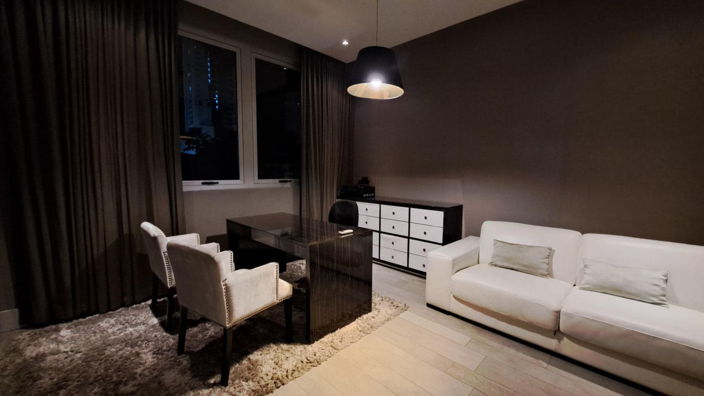 Open modern kitchen with island, stainless steel appliances, glass pantry in luxury home Panama City